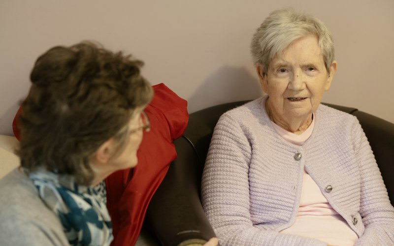 Two women sitting and talking together