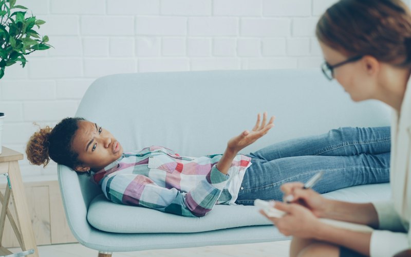 A counsellor listening to a young person during a session