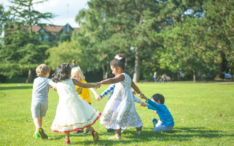 Children holding hands and playing together in a circle